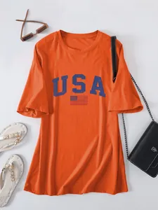 Detailed visual of a casual orange loose-fit T-shirt featuring a USA flag graphic print.