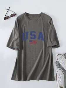 Detail view of dark grey oversized T-shirt with blue USA text and flag print