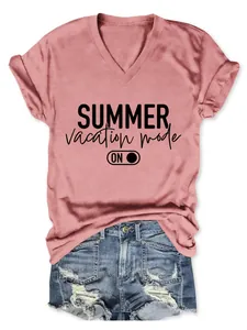 Pink V-neck T-shirt with 'Summer vacation mode' print and denim shorts flat lay