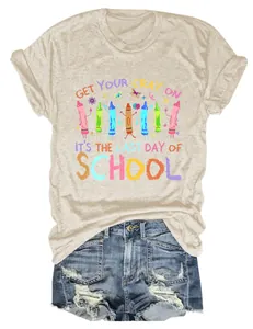 Detailed view of funny 'Last Day of School' crayon graphic on women's beige cotton T-shirt