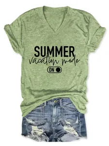 Close-up of green V-neck T-shirt with Summer Vacation Mode print and denim shorts.