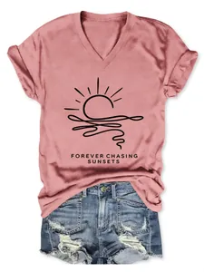 Detailed view of pink V-neck T-shirt for women featuring sunset graphic print