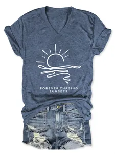 Flat lay view of blue V-neck T-shirt with 'Forever Chasing Sunsets' sun graphic print