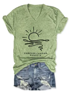 Close-up detail of a green women's V-neck t-shirt with a black sun graphic print