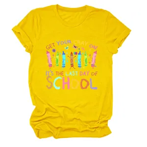 Detailed view of the yellow graphic t-shirt featuring 'Get Your Cray On' colorful school print