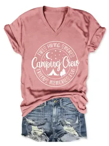 Close-up of pink V-neck T-shirt with Camping Crew graphic and distressed denim shorts.