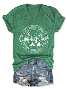 Detailed view of a green V-neck t-shirt with a white camping crew graphic print