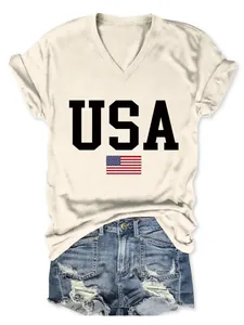 Close-up of women's cream V-neck T-shirt featuring USA text and American flag print