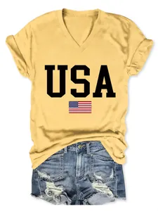 Close-up detail of yellow V-neck T-shirt with USA flag print and casual denim shorts