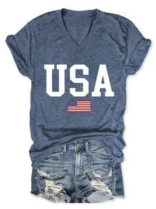 Close-up detail of the white USA letters and American flag print on the blue V-neck T-shirt