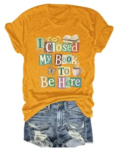 Detail of mustard yellow t-shirt with 'I Closed My Book To Be Here' graphic print