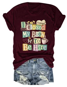 Detailed view of the 'I Closed My Book To Be Here' graphic print on a maroon T-shirt.
