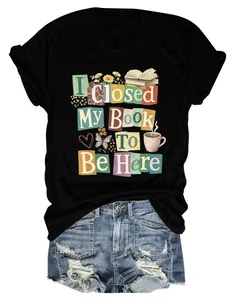 Close-up of 'I Closed My Book To Be Here' graphic print on a comfortable black T-shirt