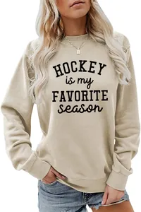 Close-up of beige sweatshirt with black 'Hockey is my favorite season' letter print