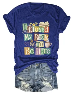 Close-up of 'I Closed My Book To Be Here' graphic print on a blue cotton T-shirt