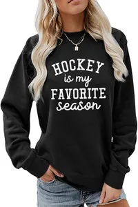 Detailed view of a black crewneck sweatshirt featuring white printed hockey slogan text.