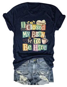 Detailed view of the 'I Closed My Book To Be Here' graphic print on a navy blue T-shirt