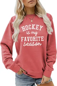 Detail view of coral sweatshirt featuring white Hockey Is My Favorite Season text print