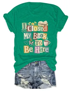 Close-up of the creative book-themed graphic print on a comfortable green women's crew neck T-shirt