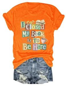 Orange t-shirt with 'I Closed My Book To Be Here' print paired with denim shorts