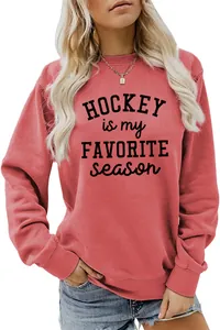 Close-up of the black 'Hockey is my Favorite Season' print on a coral red sweatshirt