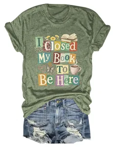 Close-up of 'I Closed My Book To Be Here' graphic print on olive green short sleeve T-shirt.