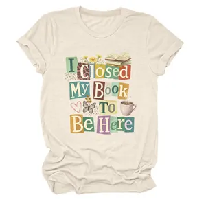 Cream graphic t-shirt featuring I Closed My Book To Be Here letter-patch design