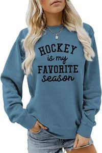 Detailed view of the Hockey Is My Favorite Season slogan print on a blue sweatshirt