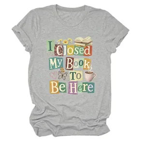 Close-up detail of the 'I Closed My Book To Be Here' colorful graphic on a gray T-shirt