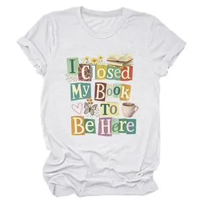 Detailed view of white women's T-shirt featuring 'I Closed My Book To Be Here' print