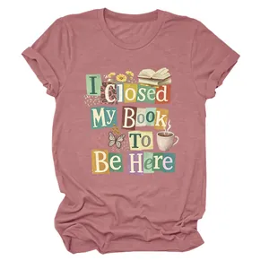 Detail of dusty pink T-shirt with 'I Closed My Book To Be Here' graphic print