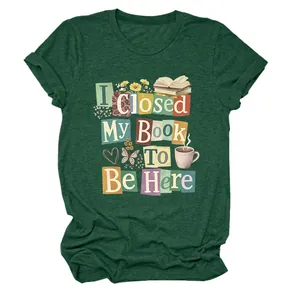 Close-up of 'I Closed My Book To Be Here' graphic on a dark green cotton T-shirt.