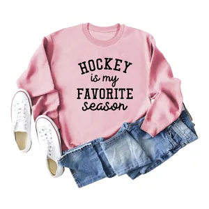 Detail of pink crewneck sweatshirt featuring Hockey Is My Favorite Season graphic print