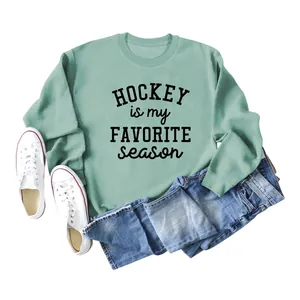 Close-up of mint green sweatshirt with 'Hockey Is My Favorite Season' text