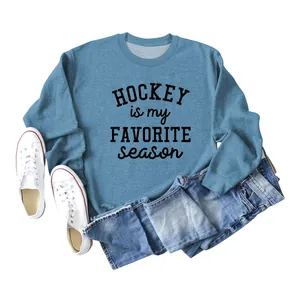 Detail of blue sweatshirt with 'Hockey Is My Favorite Season' text and casual props