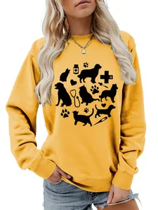 Detailed shot of yellow women's sweatshirt with cute cat, dog, and stethoscope graphic.