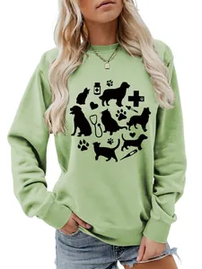Detail of light green sweatshirt featuring cute dog and cat medical theme graphic print