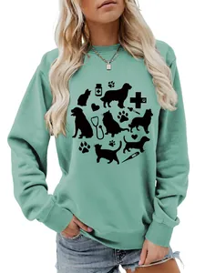 Close-up of women's mint green sweatshirt with cute pet and medical graphic prints