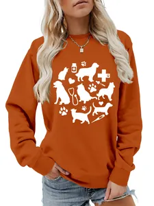 Close-up of orange sweatshirt with cute cat, dog, and medical stethoscope graphic print.