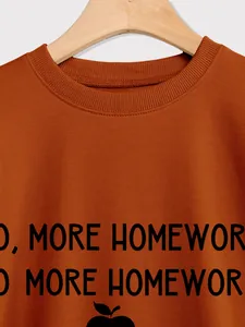 Close-up of ribbed crew neck and No More Homework print on burnt orange sweatshirt