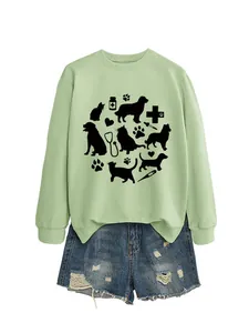 Close-up detail of light green sweatshirt featuring cute black cat and dog vet prints.