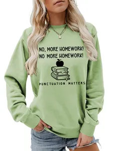 Close-up of women's light green sweatshirt featuring 'No More Homework' graphic print