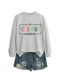 Close-up detail of a gray pediatric nurse crewneck sweatshirt with colorful text