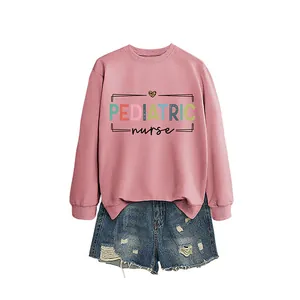 Comfortable pink pediatric nurse crewneck sweatshirt with distressed denim shorts