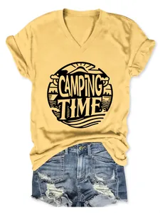 Close-up detail of a yellow V-neck T-shirt featuring 'Camping Time' print with denim shorts