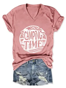 Detail view of women's pink V-neck T-shirt with Camping Time graphic and denim shorts