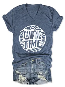 Close-up of white Camping Time graphic print on a navy blue V-neck t-shirt and denim shorts