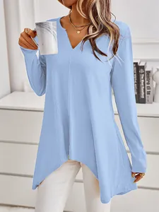 Detailed view of women's light blue long sleeve V-neck ribbed knit tunic top on a model
