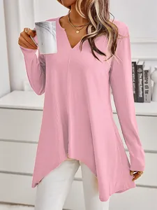 Detailed view of women's pink ribbed knit sweater with a notched neckline and irregular hem.
