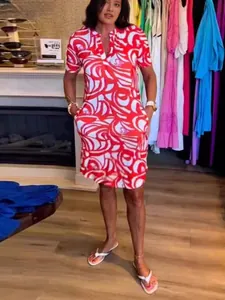 Casual V-neck short-sleeved dress with a vibrant red and white abstract swirl print
